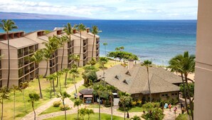 A hotel with multiple buildings, a pool area, and a view of the ocean. - Kaanapali Shores Resort by KBM (Lahaina)