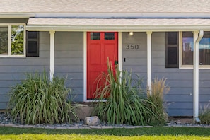 A house with a red door, number 350, and a porch with plants. - Mesa Manor: Comfortable & Modern Family Retreat (Fruita)