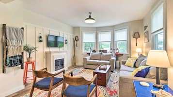 A cozy living room with a fireplace, a sofa, and a coffee table.