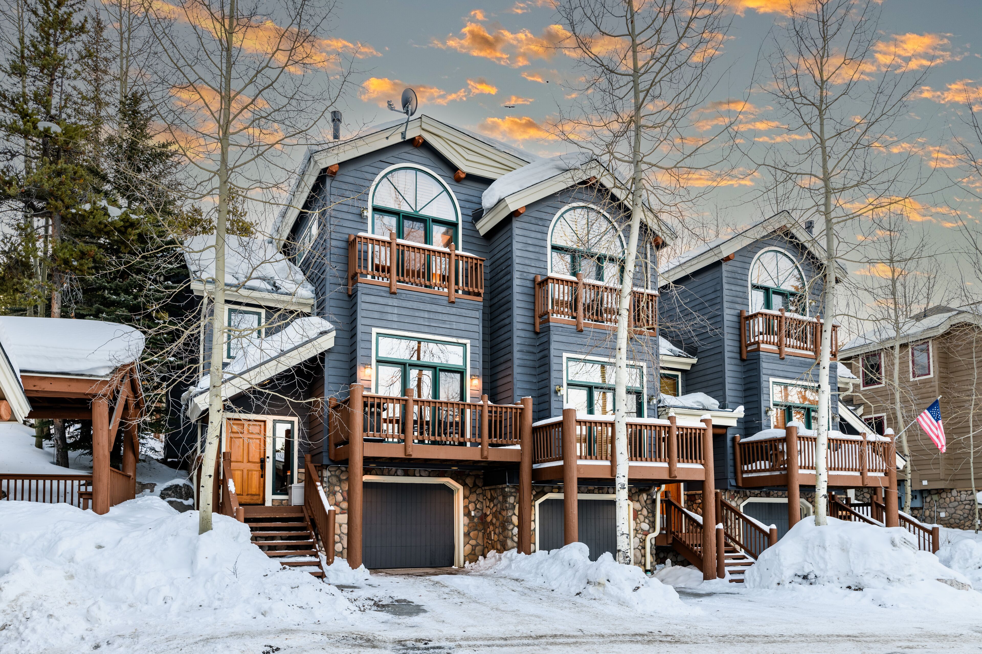 A multi-story house with a balcony, a garage, and a staircase.