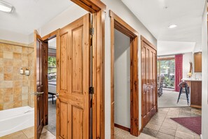 A modern bathroom with a bathtub, a shower, and a toilet. - Close to Peak 9, On Main St, Shared Pool/Hot Tubs. (Breckenridge)
