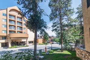 A multi-story building with balconies, surrounded by trees and a well-maintained lawn. - Newly Remodeled/Furnished at Peak 9 Base/Downtown (Breckenridge)