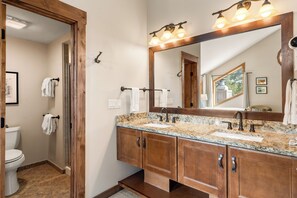 A bathroom with a double sink, wooden vanity, a large mirror, and a shower area. - Mountain Views! Near Ski Run & Free Ski Shuttle (Breckenridge)