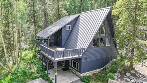 A cabin with a balcony, surrounded by trees. - Adventure Awaits! Cozy Aframe 5 Min to Breck. (Breckenridge)