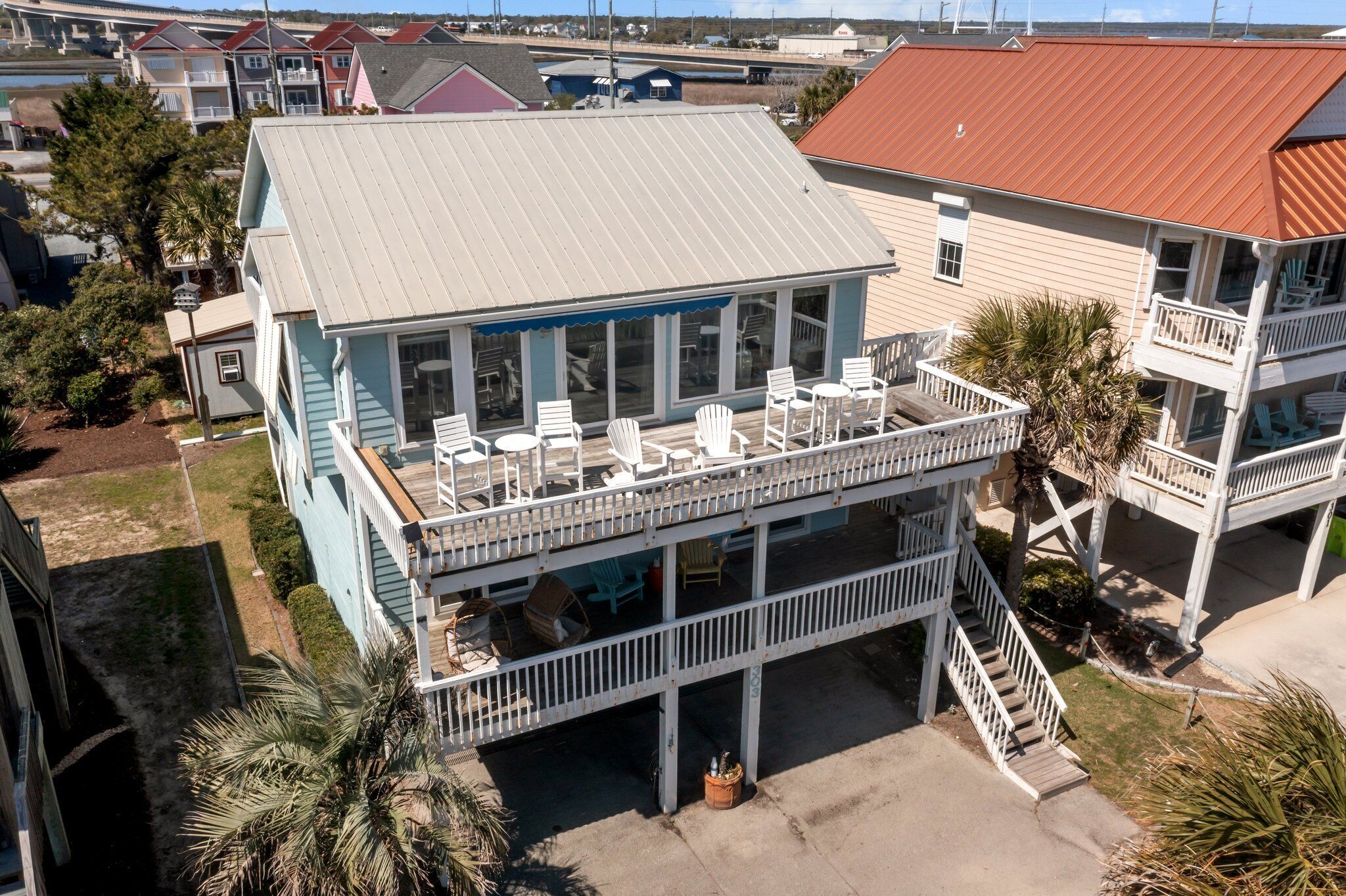 A two-story building with a balcony and outdoor seating area.