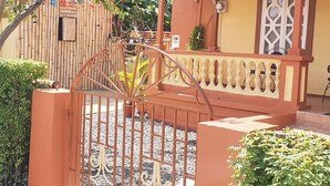 A gated entrance with a metal gate and a decorative railing. - Mesmerize Guest House (Port Antonio)