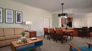 A modern living room with a sofa, coffee table, and dining area with chairs. There is a kitchen in the background with a microwave and cabinets. - Marriott's Canyon Villas: Direct from Owner, Luxury 2 bedroom Thanksgiving  Week (Phoenix)