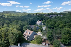 Surrounded by lush forested hills, this modern residential area offers a serene natural setting.