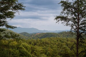 A mountainous landscape with dense forest and a clear sky. - Tiny Cabin -Built in 2022- with Amazing View and Hot Tub! (Sevierville)