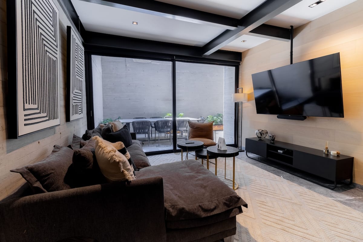 Deluxe appartement, 1 slaapkamer, patio | Woonruimte | Een ledtelevisie, slimme speakers, streamingdiensten en een printer