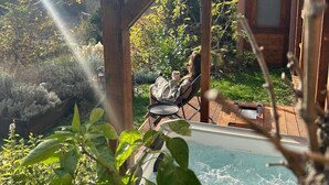 A wooden deck with a hot tub, surrounded by lush greenery and a clear sky. - Villa Chill House Keti - private pool and jaccuzzi (Kuzminec)