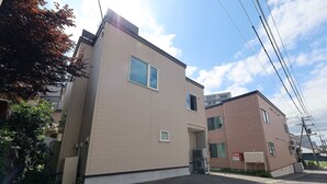 A two-story building with a flat roof and a brick facade. - The Beehive Otaru (Otaru)