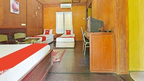 A hotel room with two beds, a television, a desk, and a chair. - OYO 90595 Pelangi Beach Resort Cherating (Cherating)