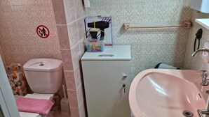 A small bathroom with a toilet, a cabinet, and a sink. - Stadion apt 2 Near Athens city center (Athina)