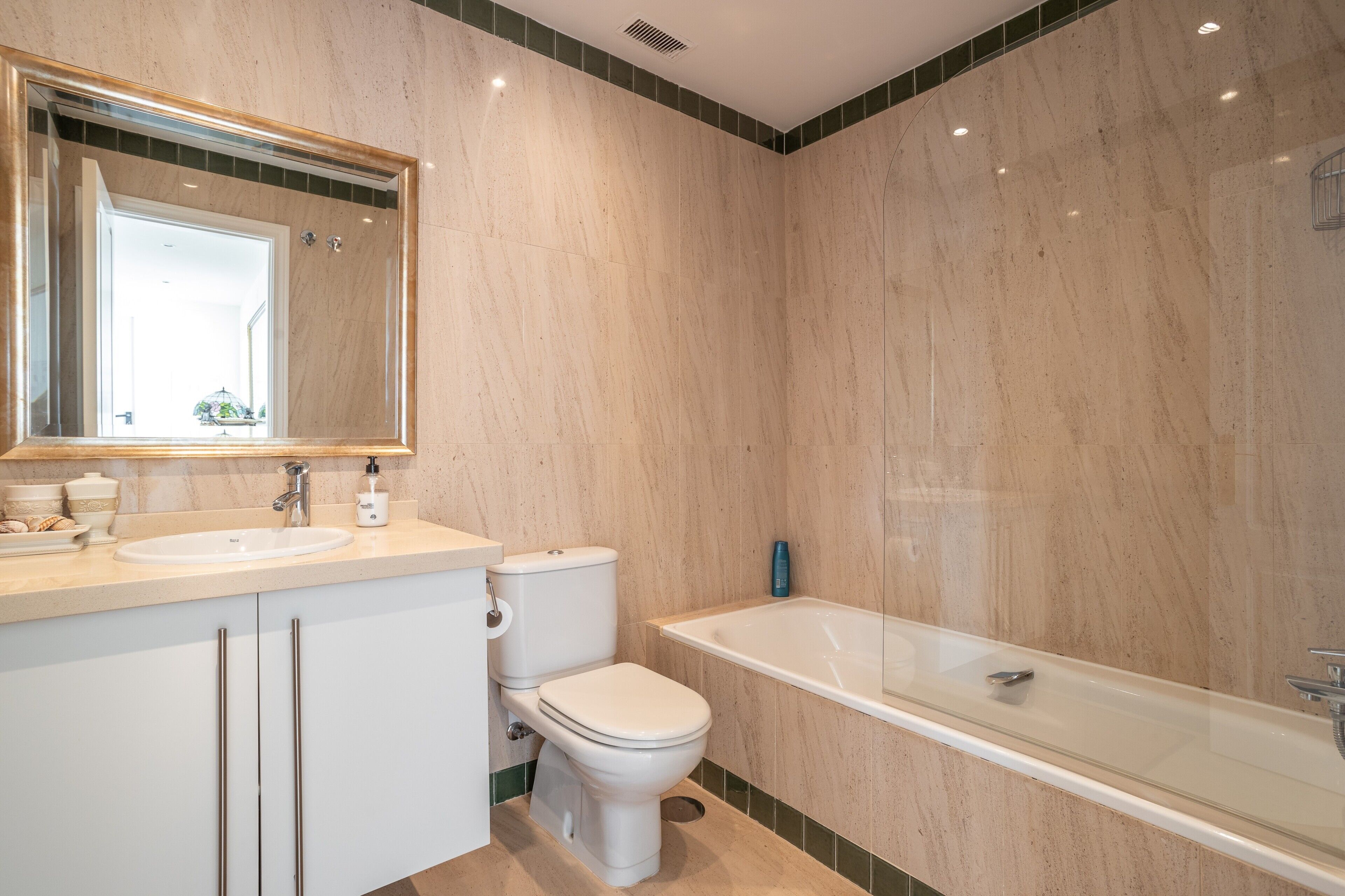 A bathroom with a sink, toilet, and bathtub.