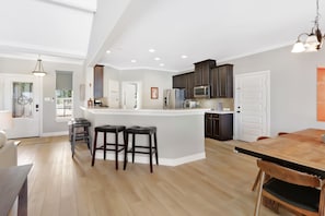Enjoy meals and gatherings in this kitchen with a central island and dining area.