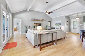 Relax in this inviting living area with a sofa, coffee table, and dining space.