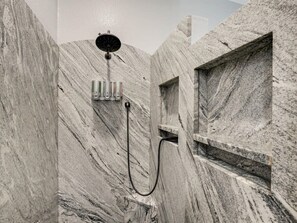 Bathtub, hair dryer, towels, shampoo