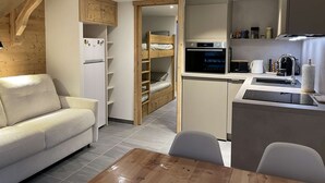 A compact kitchen with a built-in oven, a sink, and a coffee machine. - Corniche A19 Studio mezzanine 650m from ski slopes (MORZINE)