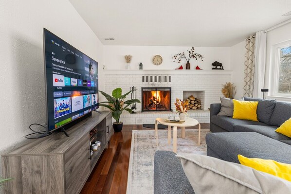 Smart TV, fireplace, books, computer monitors