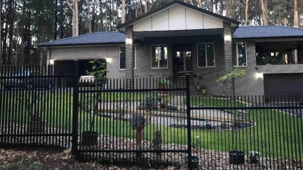 A two-story house with a brick exterior, a front porch, and a driveway. - Cosy apartment close to Puffing Billy  (Clematis)