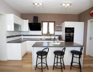 Enjoy cooking in this well-lit kitchen with a central island and oven.