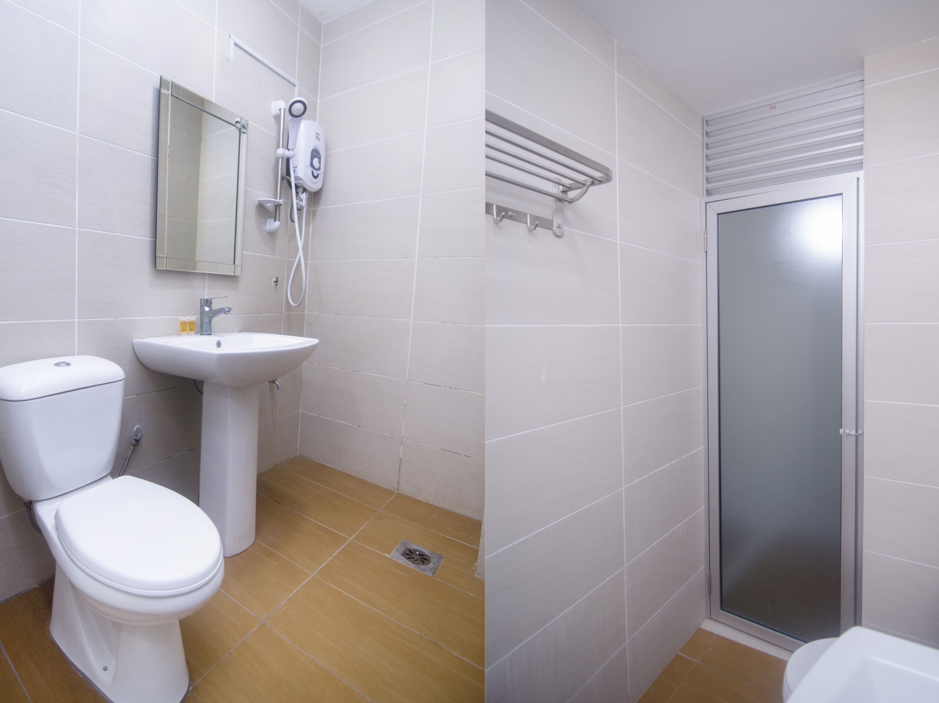 A bathroom with a toilet, sink, and shower.