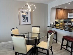 A modern kitchen with wooden cabinets, a stainless steel sink, and a built-in oven. - DIRECT BEACHFRONT Views from the 15TH FLOOR! Listen to Ocean Waves! WOW! (Jensen Beach)