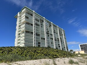 A high-rise hotel with multiple balconies and a clear view of the sky. - DIRECT BEACHFRONT Views from the 15TH FLOOR! Listen to Ocean Waves! WOW! (Jensen Beach)