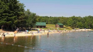 A lakeside park with a sandy beach, picnic areas, and a small cabin. - Poconos Hideaway Hot Tub, Zen Garden & Fire Pit, hiking and water parks nearby. (Albrightsville)
