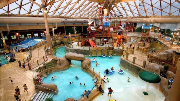 An indoor water park with multiple pools, slides, and water play areas. - Poconos Hideaway Hot Tub, Zen Garden & Fire Pit, hiking and water parks nearby. (Albrightsville)