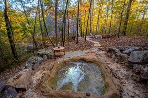 A hot spring surrounded by rocks and trees in a forest. - The Bridge House Rock Hot Tub Buffalo River (Saint Joe)