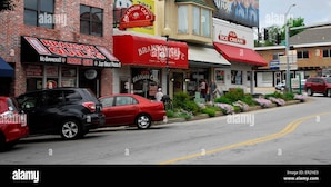 A street view with a brick building featuring a sign for Branson Quilts and a nearby ice cream shop. - FALLS - Shop Till You Drop, Then Relax in a Comfortable Studio Suite (Branson)