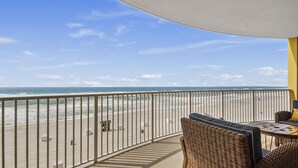 A balcony with a view of the beach and ocean. - Emerald Isle 506 - Beautiful beachfront condo! Front row chairs included! (Panama City Beach)