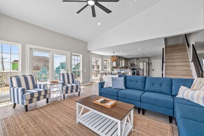 Relax in this stylish living area with a large sofa, coffee table, and comfortable armchairs.
