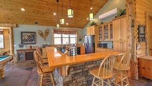 A wooden interior with a bar area, stone walls, and a pool table. - Windsong Retreat | 3X2 PROMO | Lake Views. Hot tub (Big Bear Lake)