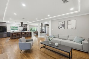 A modern living room with a sofa, armchair, and coffee table.