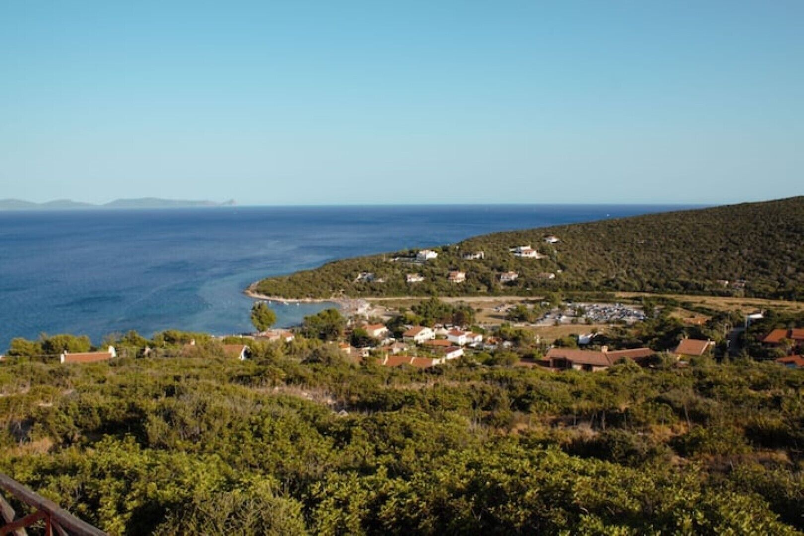 A coastal village with houses on a hillside overlooking the sea.