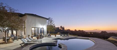 A heated pool, sun loungers