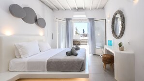 A modern bedroom with a large bed, a bedside table, and a view of the outdoors.