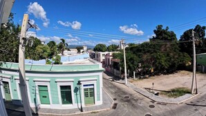 A street view with buildings, a clear sky, and a visible power line. - Apartment Double Bed- Sleeps 2 - Free WIFI (Ponce)