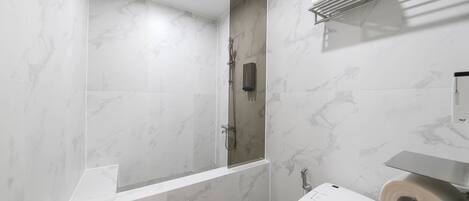 A modern bathroom with a shower, toilet, and a towel rack.
