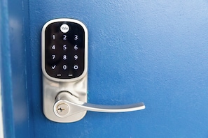 A blue door with a numeric keypad lock. - Anchor Bay Inn and Suites (Sandusky)