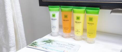A bathroom counter with four Mikado SPF3 skincare products and a travel brochure.