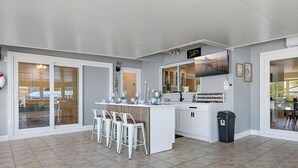 Una cocina moderna con barra, ventanas grandes y vistas al exterior.
