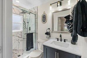Combined shower/tub, hair dryer, towels, soap