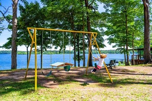 Une balançoire dans un parc avec vue sur un lac.
