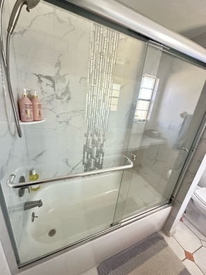 Combined shower/tub, hair dryer, towels, soap