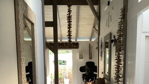 A hallway with a wooden bench, decorative mirrors, and a white woven basket. - PROMO: CHARMING POOL VILLA LES TROIS ILETS 3 bedrooms sleeps 8. WATCH  (Les trois ilets)
