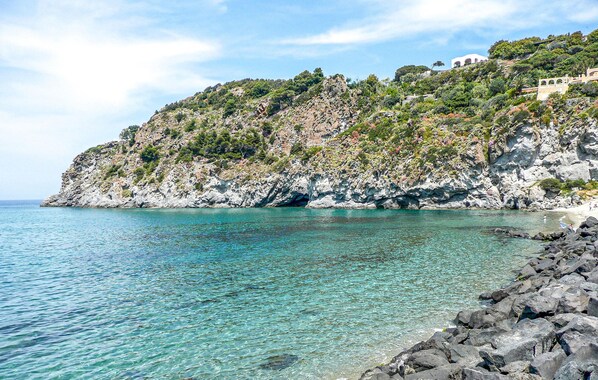 Experience the rugged coastline with turquoise waters and lush greenery.
